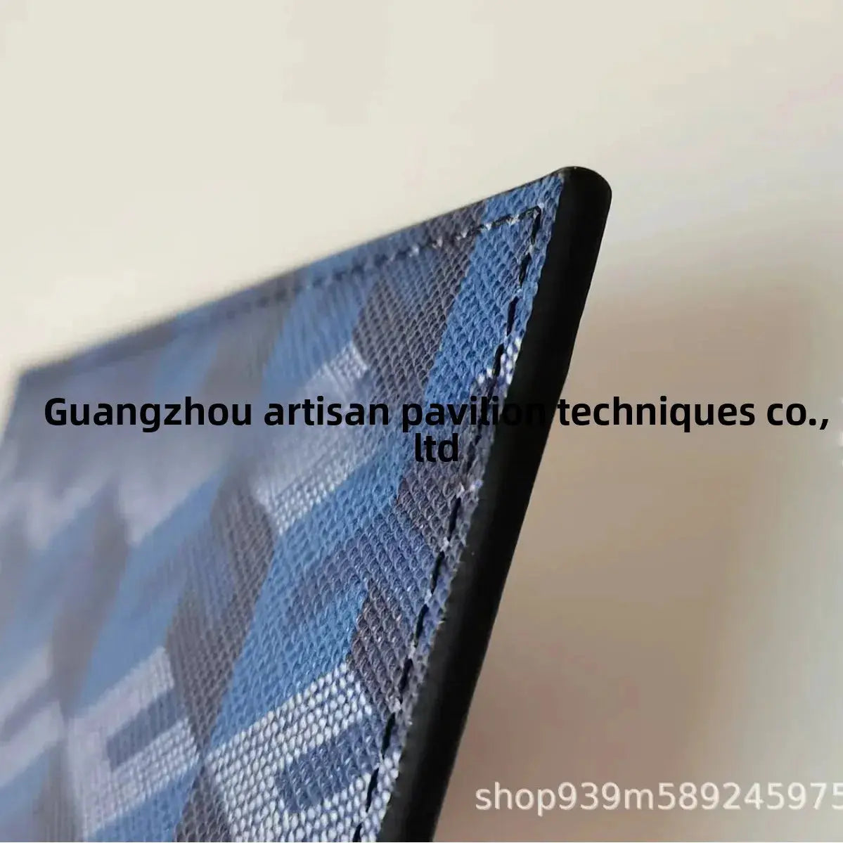 Card holder in blue genuine leather with a 3D pattern and black edge stitching; compact multi-functional wallet.