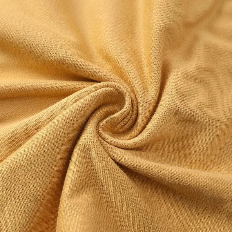 Beige fabric swatch close-up of soft knit jersey material.
