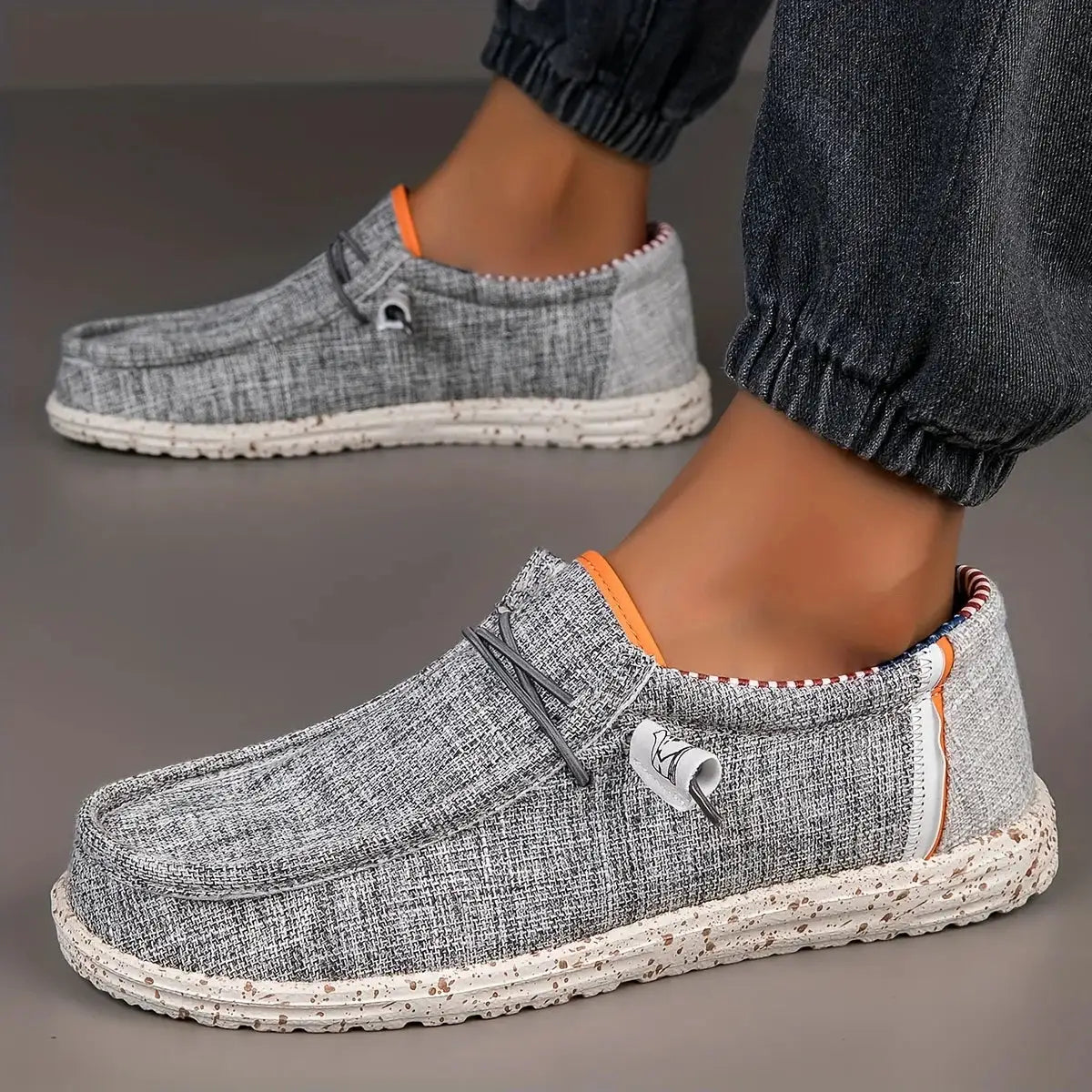 Men's canvas loafers; grey slip-ons with orange trim and speckled sole (2 shoes shown)