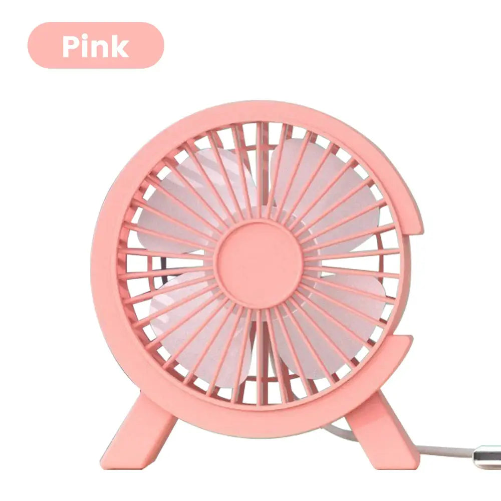 Pink mini USB rechargeable table fan with round grill and small stand; USB cable visible for dorm, office, or home use.