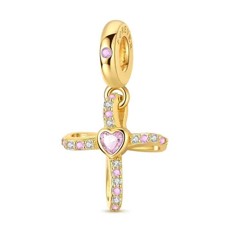 Gold-tone cross charm pendant with pink heart center and pink and clear crystals on bracelet bail
