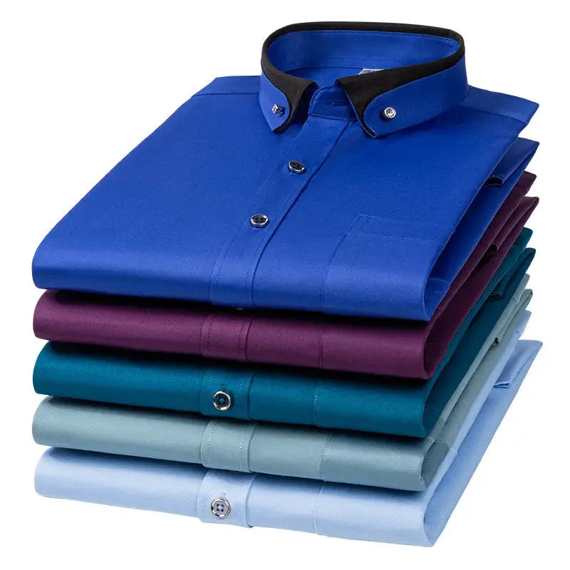 Men's business dress shirts stack in blue and assorted colors with button-down collars.