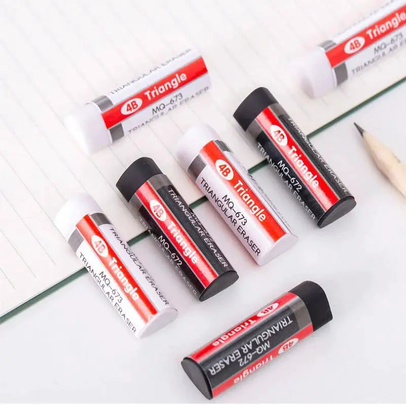 Triangle erasers set in white and black cylinders with red labels, arranged on notebook pages