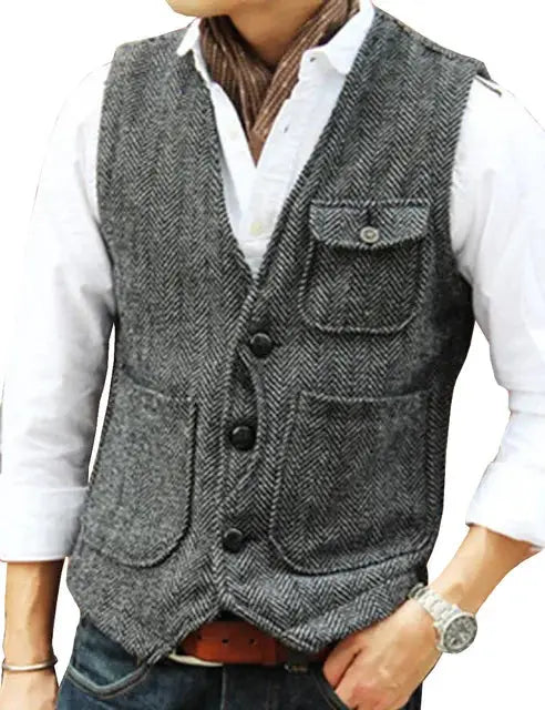 Men's grey herringbone wool tweed vest with V-neck, three-button front, and patch pockets