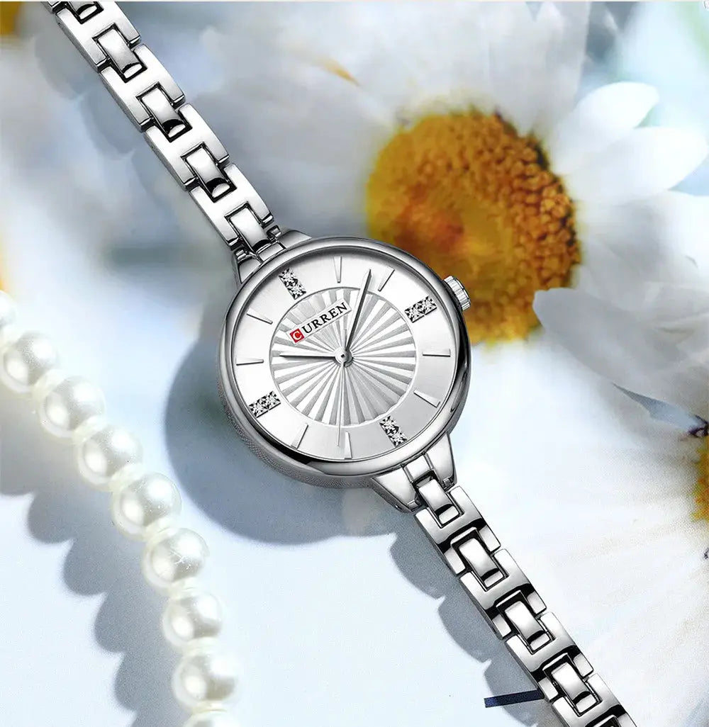 CURREN women's quartz watch with silver stainless-steel bracelet and round dial.