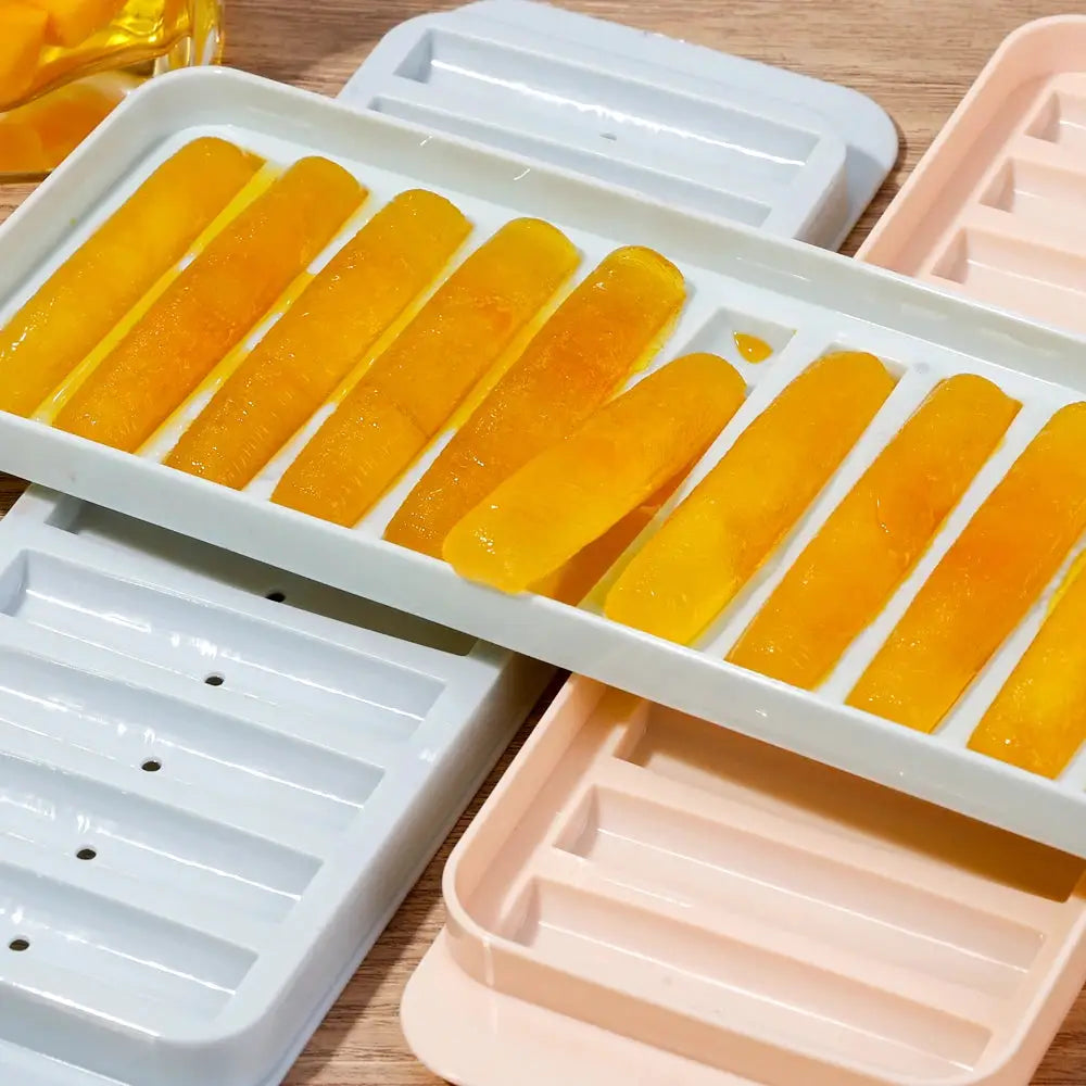 Long bar ice cube mold with orange-yellow cylindrical ice bars, 9 pieces in a white tray.
