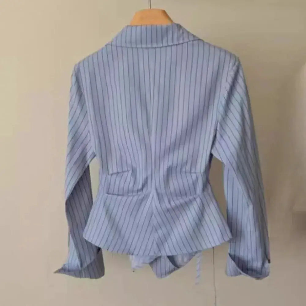 Blue striped women's long-sleeve blouse with peplum waist, back view