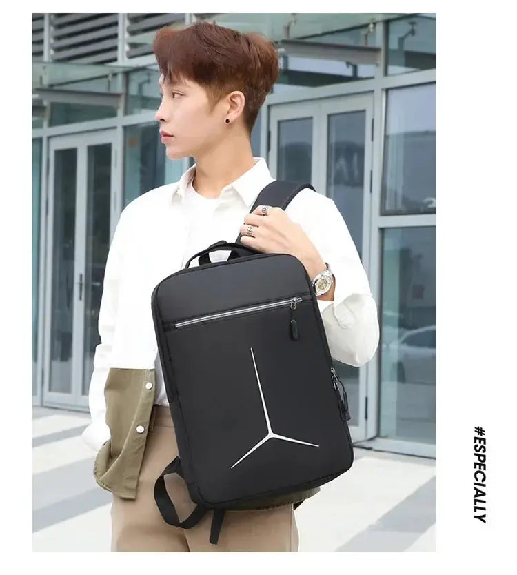 Anti-theft waterproof laptop backpack in black with white geometric design, carried by a man in a white shirt.