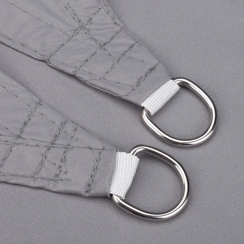 Simples Market triangle shade sail strap with metal D-rings on gray fabric