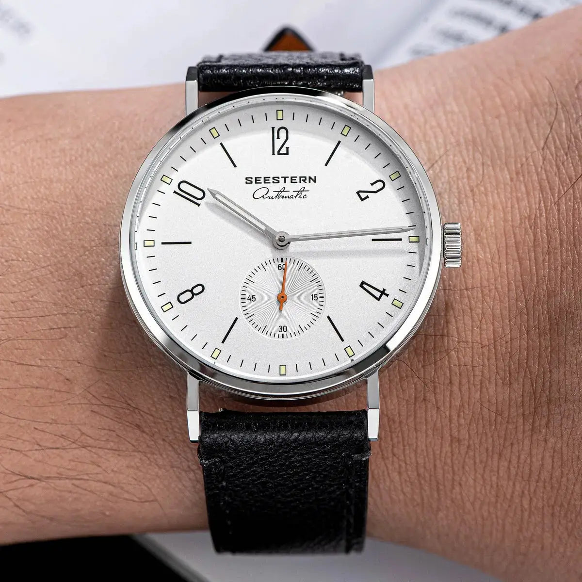 Seestern automatic men’s wristwatch with white dial, stainless steel case, and black leather strap.