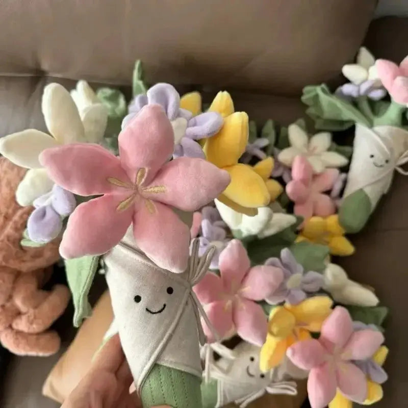Plush flower bouquet with pastel pink, yellow, and purple petals and smiling-face fabric stems.