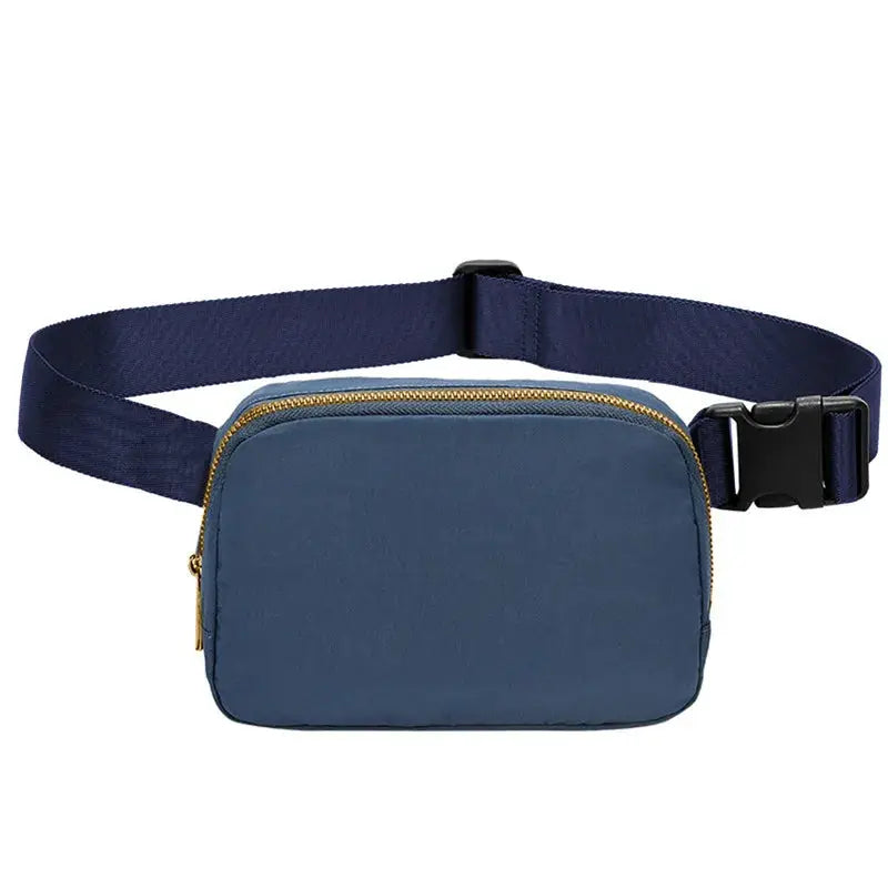 Waist bag in blue with gold zipper and adjustable navy strap