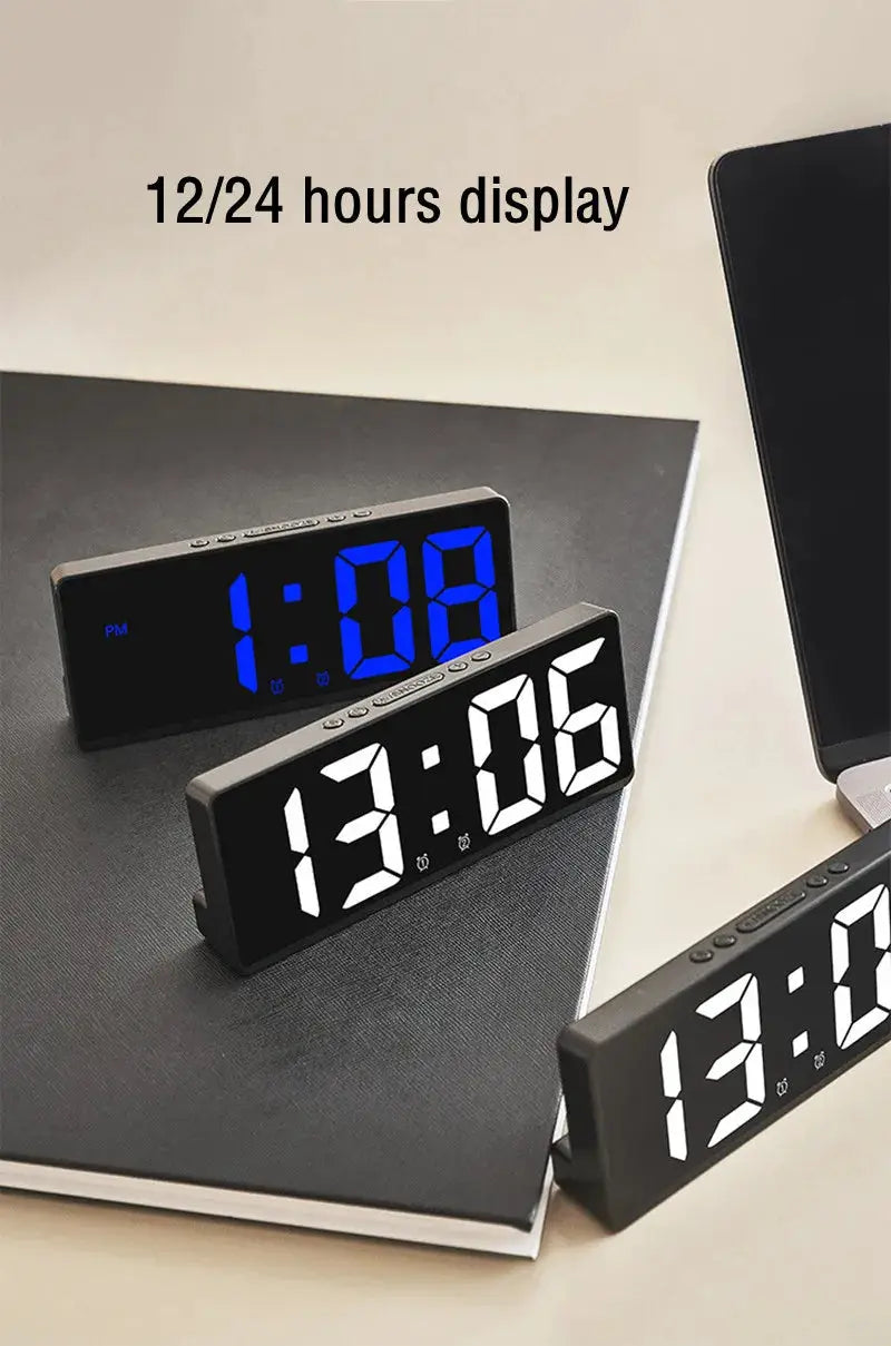 Three black acrylic/mirror digital alarm clocks with 12/24h LED display on desk