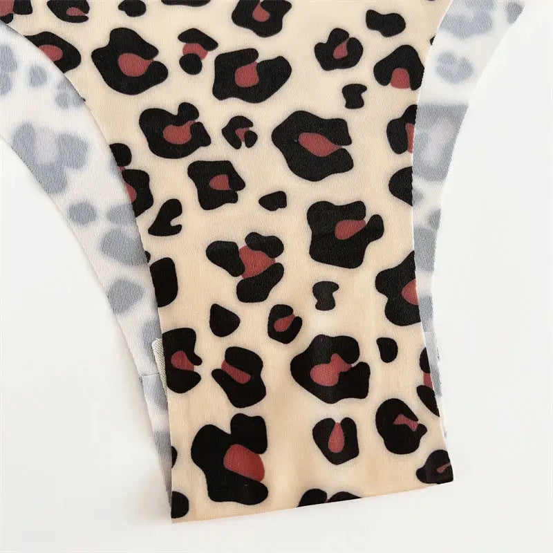 Leopard print ultra-soft seamless thong underwear with beige fabric and black spots, gray waistband.