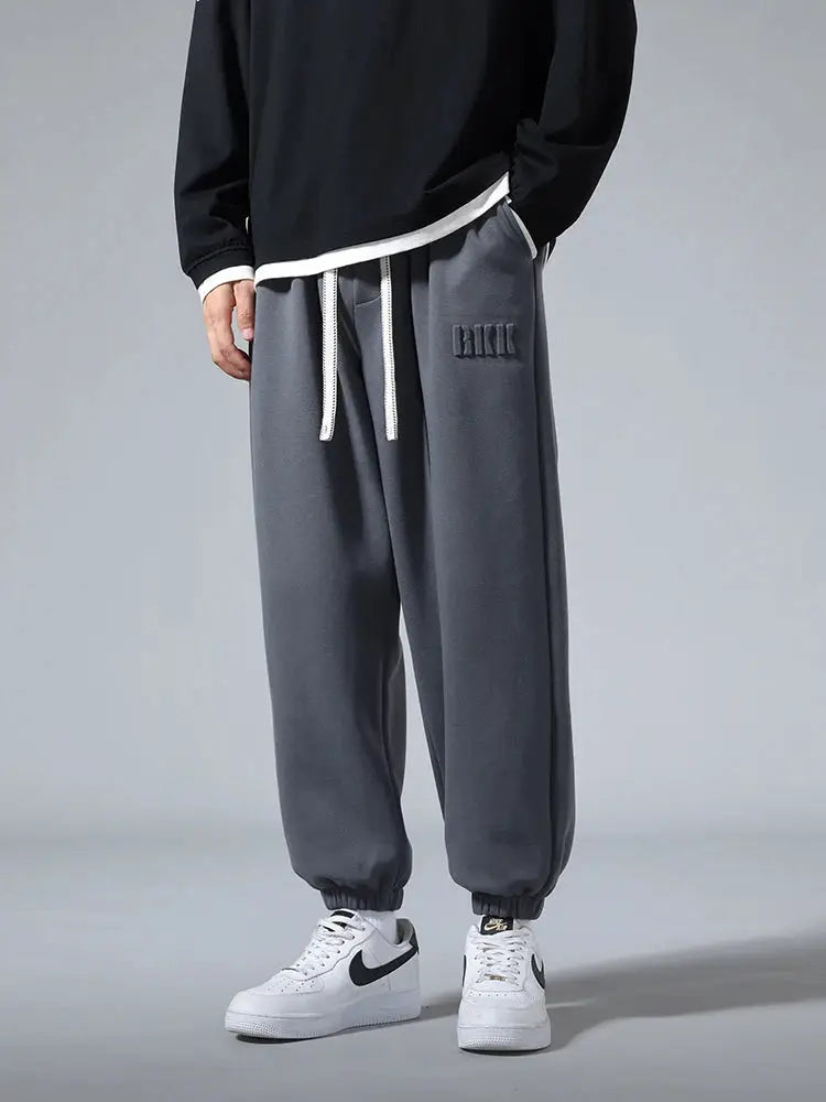 Men's gray cotton/polyester joggers with white drawstring, cuffed ankles, Simples Market.