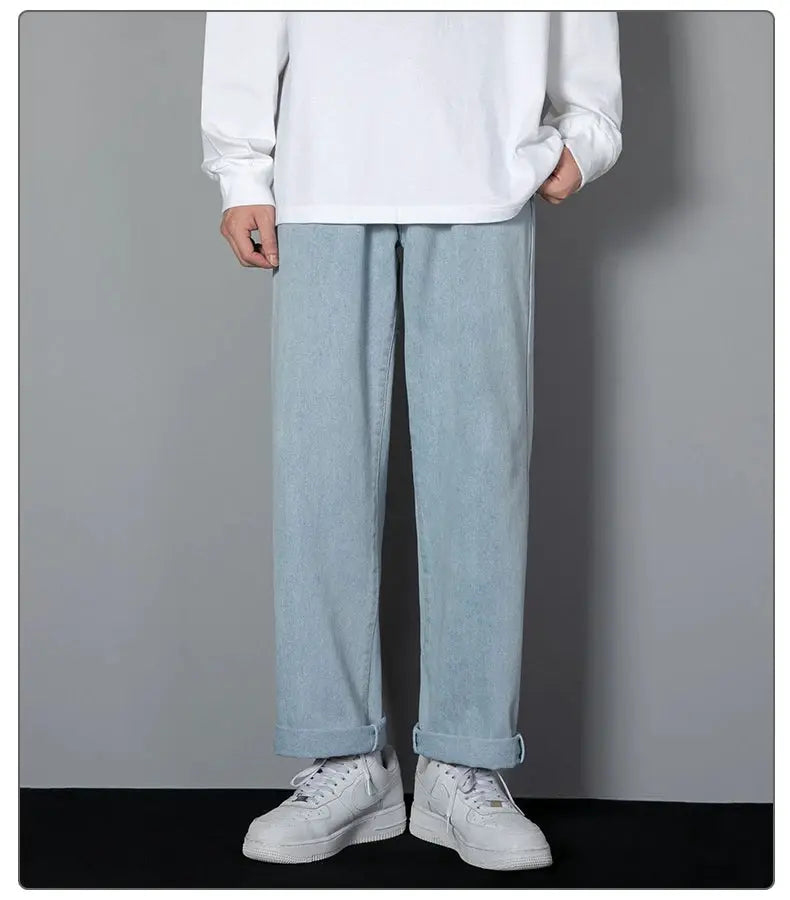 Men's light blue denim long jeans with a wide-leg straight fit and rolled cuffs.