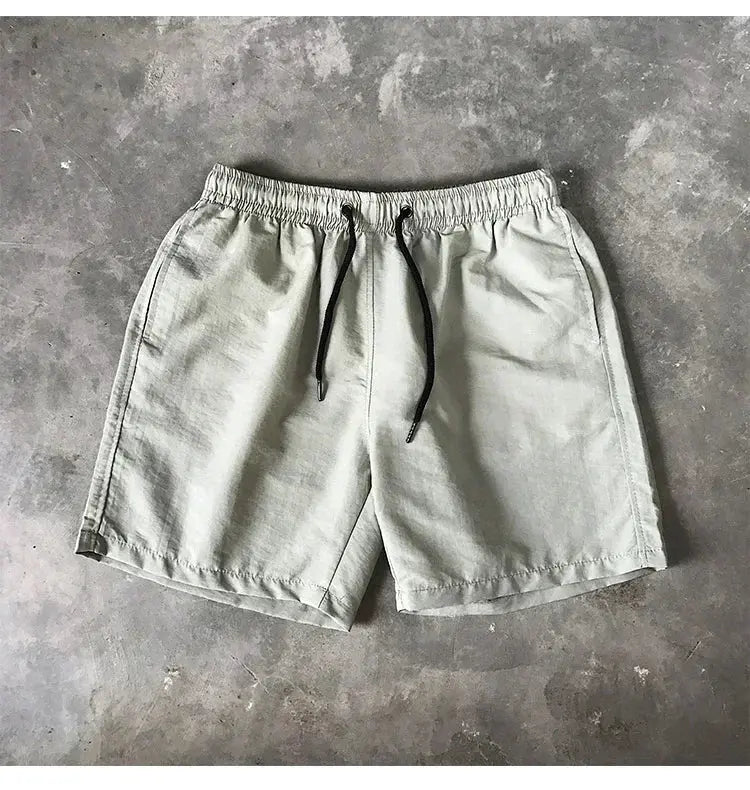 Men's swim shorts, Simples Market, light gray with black drawstring and elastic waistband.