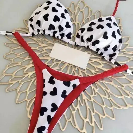 Two-piece bikini swimsuit by Simples Market, white heart-print top with red-trim thong bottom