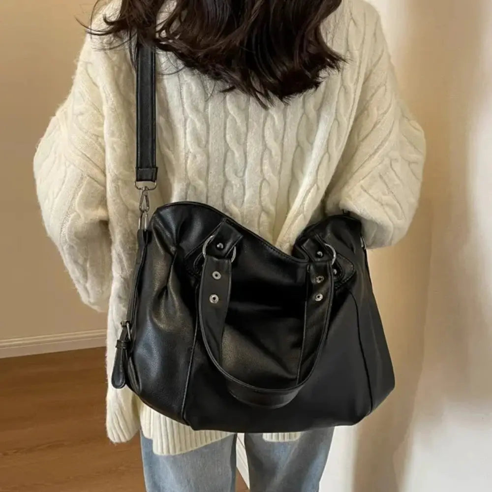 Soft interior compartment shoulder bag in black PU leather with dual top handles and adjustable strap