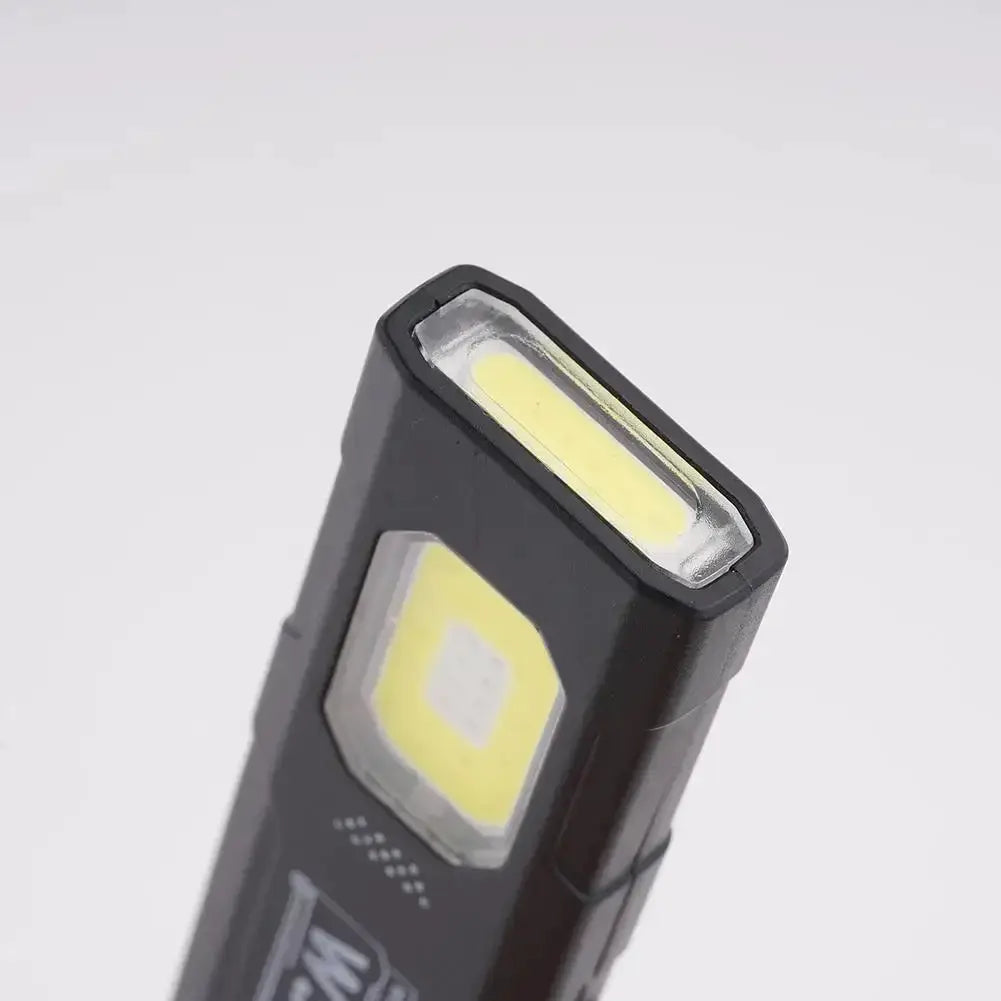 Powerful mini COB LED keychain flashlight, black USB-C rechargeable pocket hanging work light with dual LED panels.