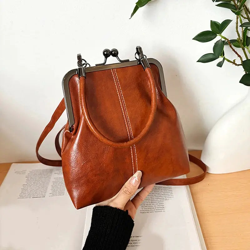 Brown PU leather vintage-style women's handbag with metal frame clasp and crossbody strap