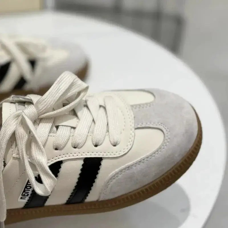 Women’s white sneakers with black side stripes, lace-up, round toe, gum sole