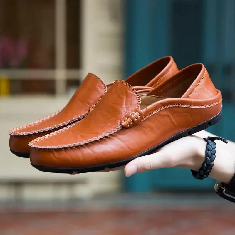 Pair of men's brown leather loafers moccasins, slip-on with braided stitching detail
