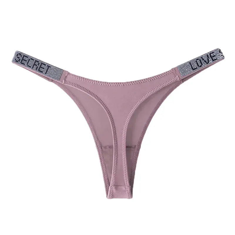 Low waist pink thong with rhinestone-embellished side straps reading SECRET and LOVE