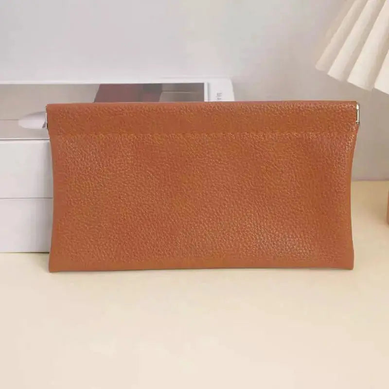 Self-closing brown artificial leather long wallet with pebbled texture
