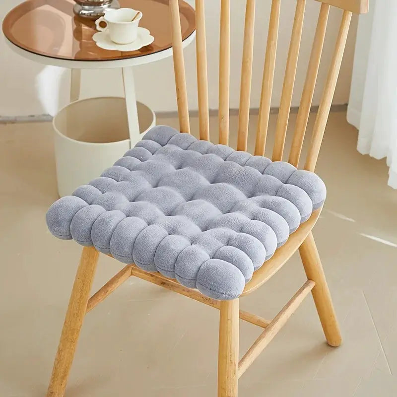 Large biscuit-shaped plush cushion chair seat pad in gray, tufted bubble design for cozy seating