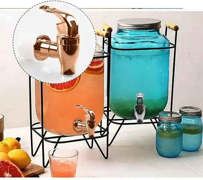 Two beverage dispensers with copper electroplated taps on metal stands, glass jars filled with orange and blue liquids