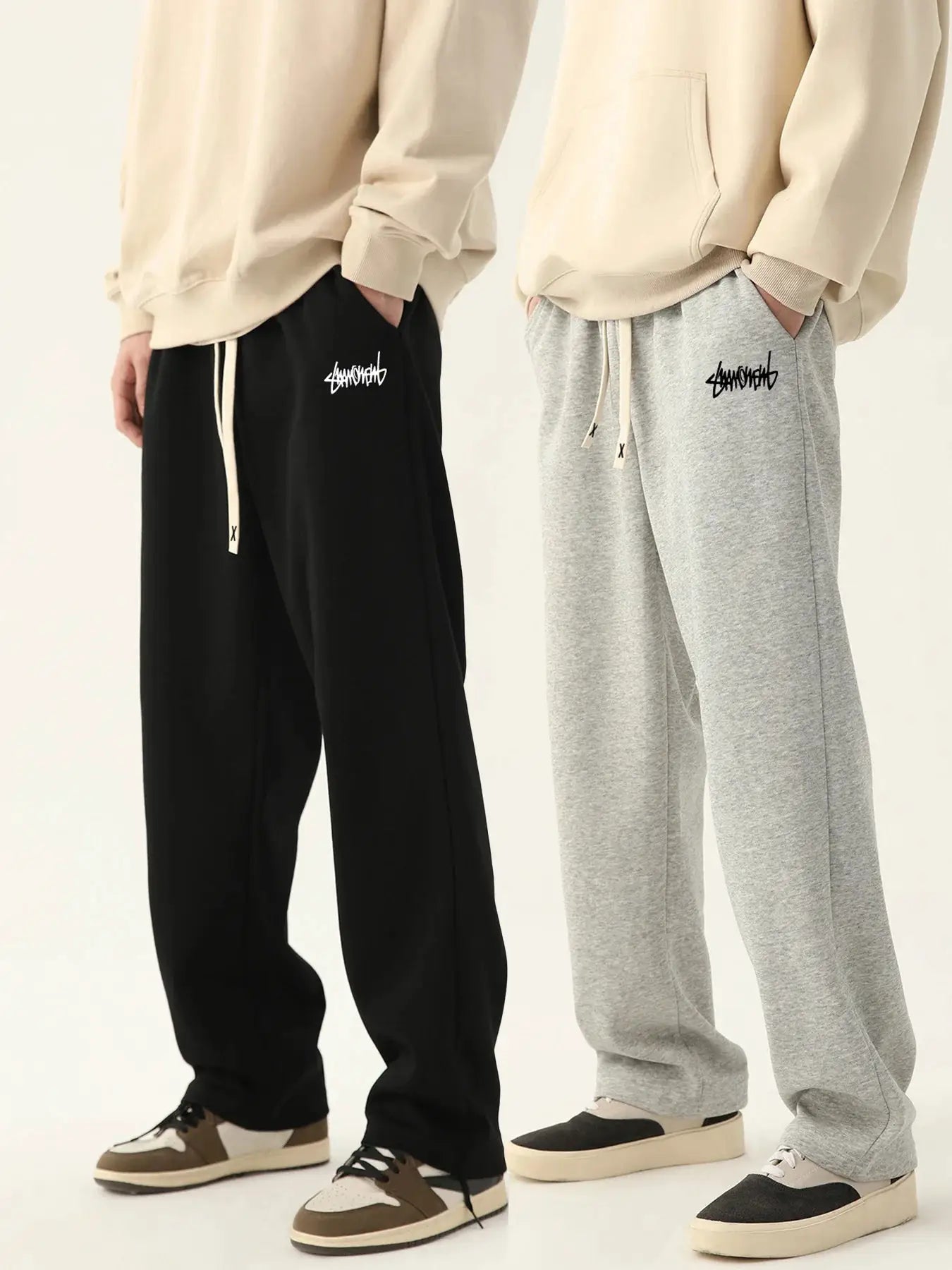 Men's jogging pants by Simples Market; baggy black and grey sweatpants with drawstrings and logo patches, two pairs