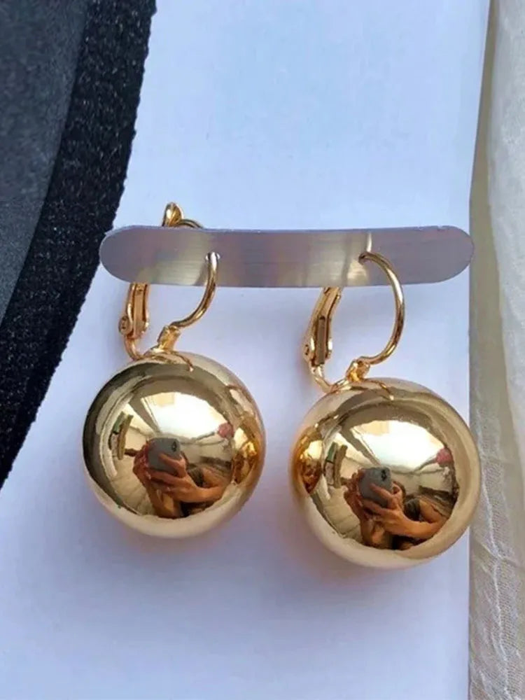 Gold-tone ball drop earrings; hoop style with smooth spherical pendants (pair)