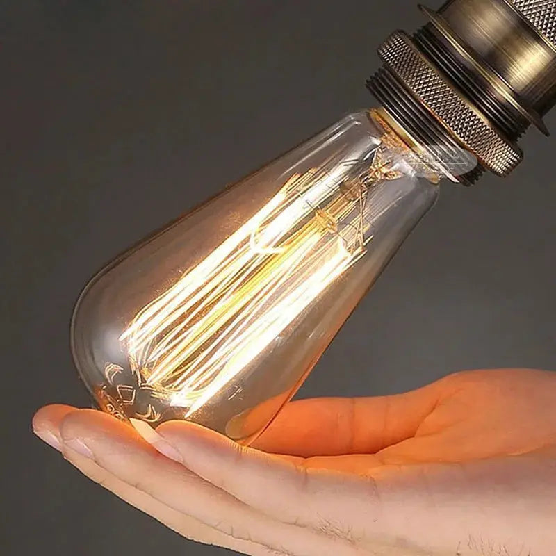 Retro Edison bulb E27 with warm filament, clear glass, held in hand