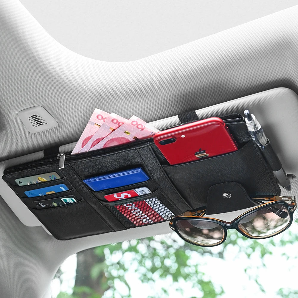 Black car sun visor organizer with sunglasses clip, card slots, and pen holder