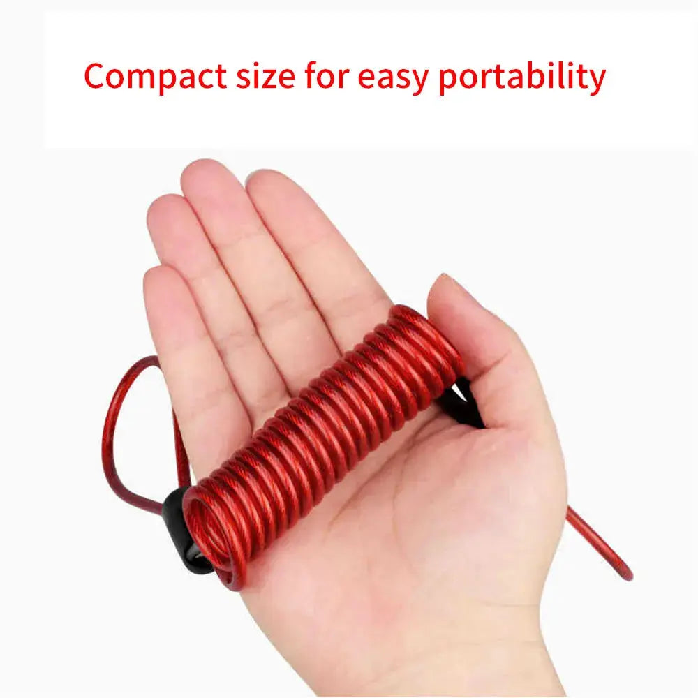 Red coiled reminder cable lock for motorcycle held in hand