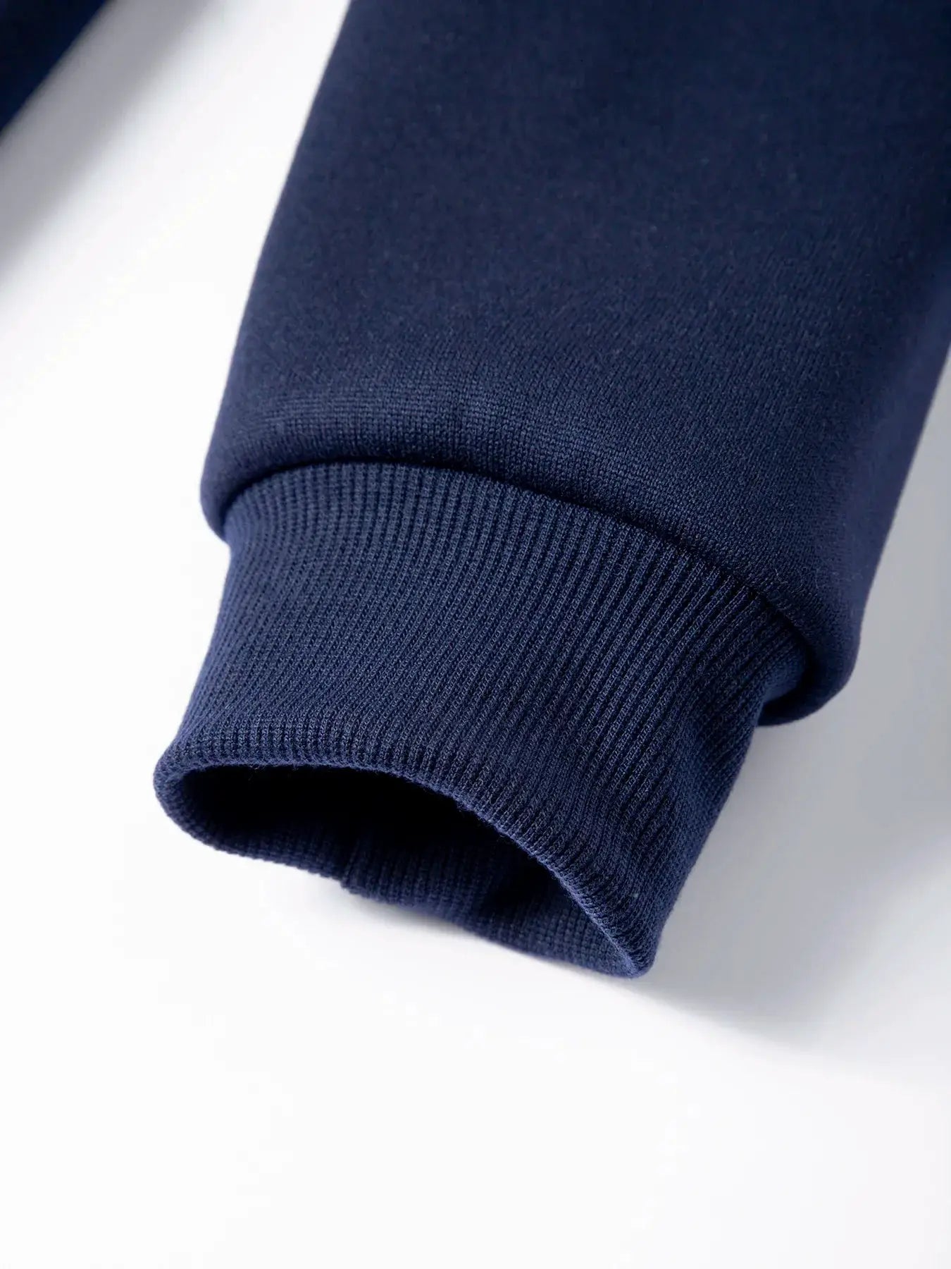 Men's navy blue knit pullover sweater ribbed sleeve cuff.