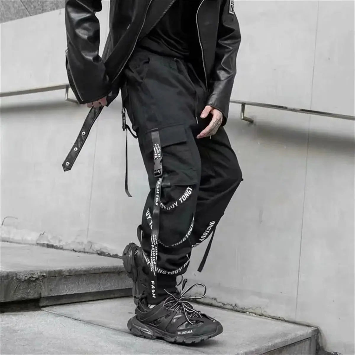 Black cargo pants for men by Simples Market with multiple utility pockets, straps, and a jogger-style fit
