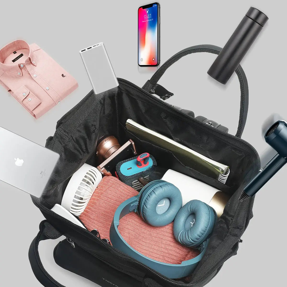 Tigernu women's splashproof backpack opened to show laptop, headphones and gadgets inside