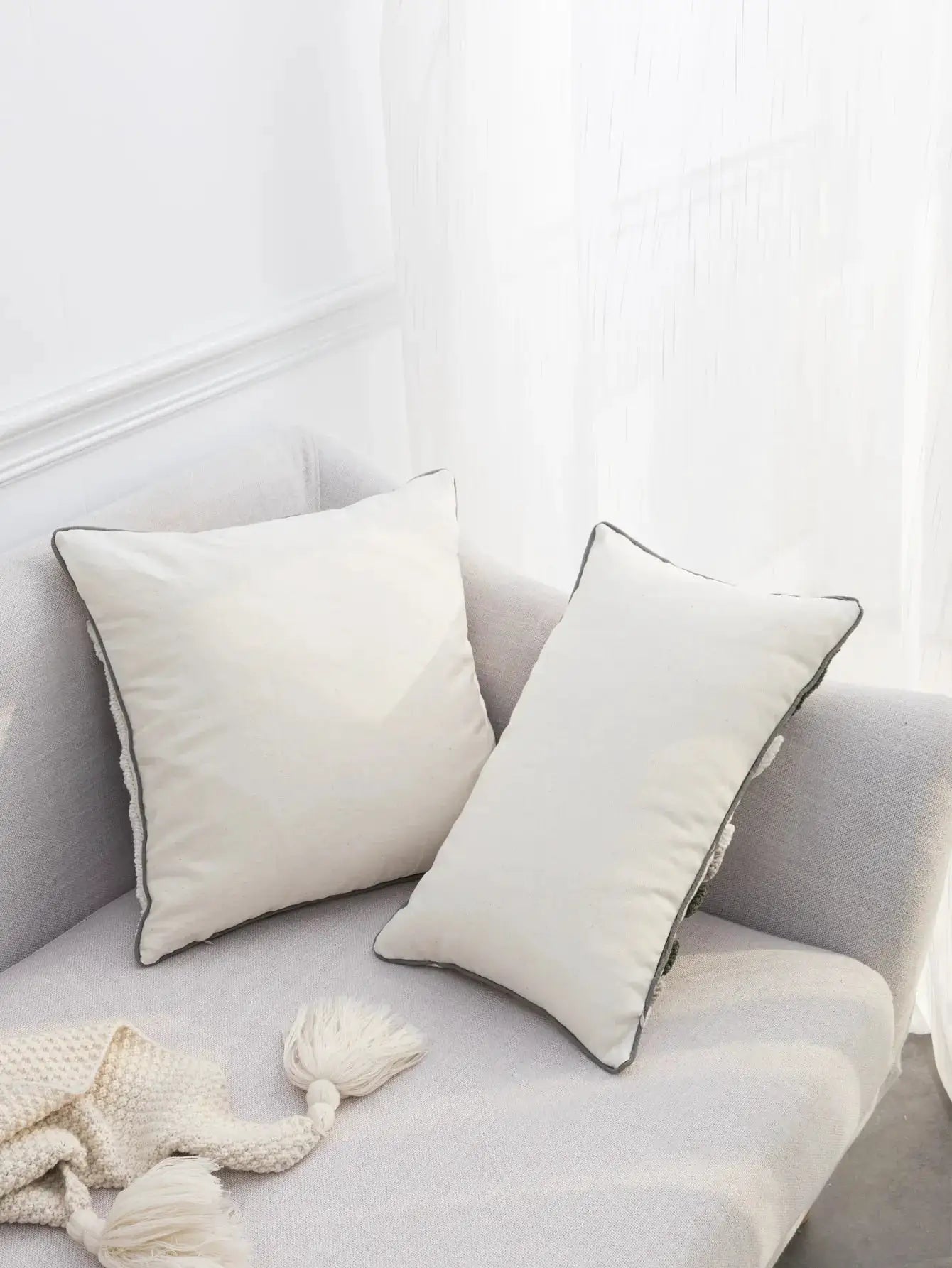 2 cream pillow covers with dark piping on a light sofa, Simples Market bohemian style