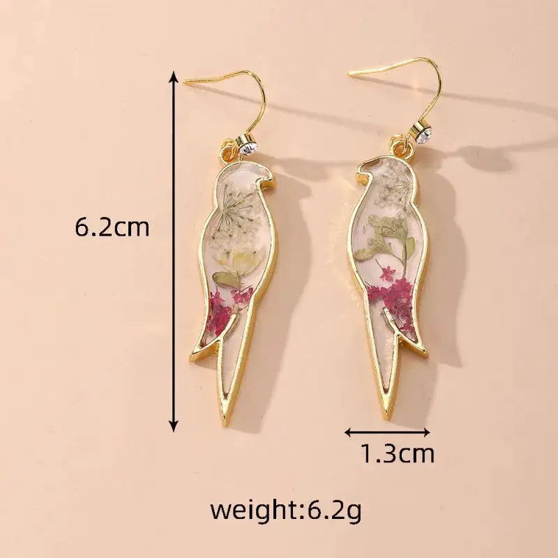 Natural flower dangle earrings with gold-tone frames and clear epoxy containing colorful pressed flowers; pair.