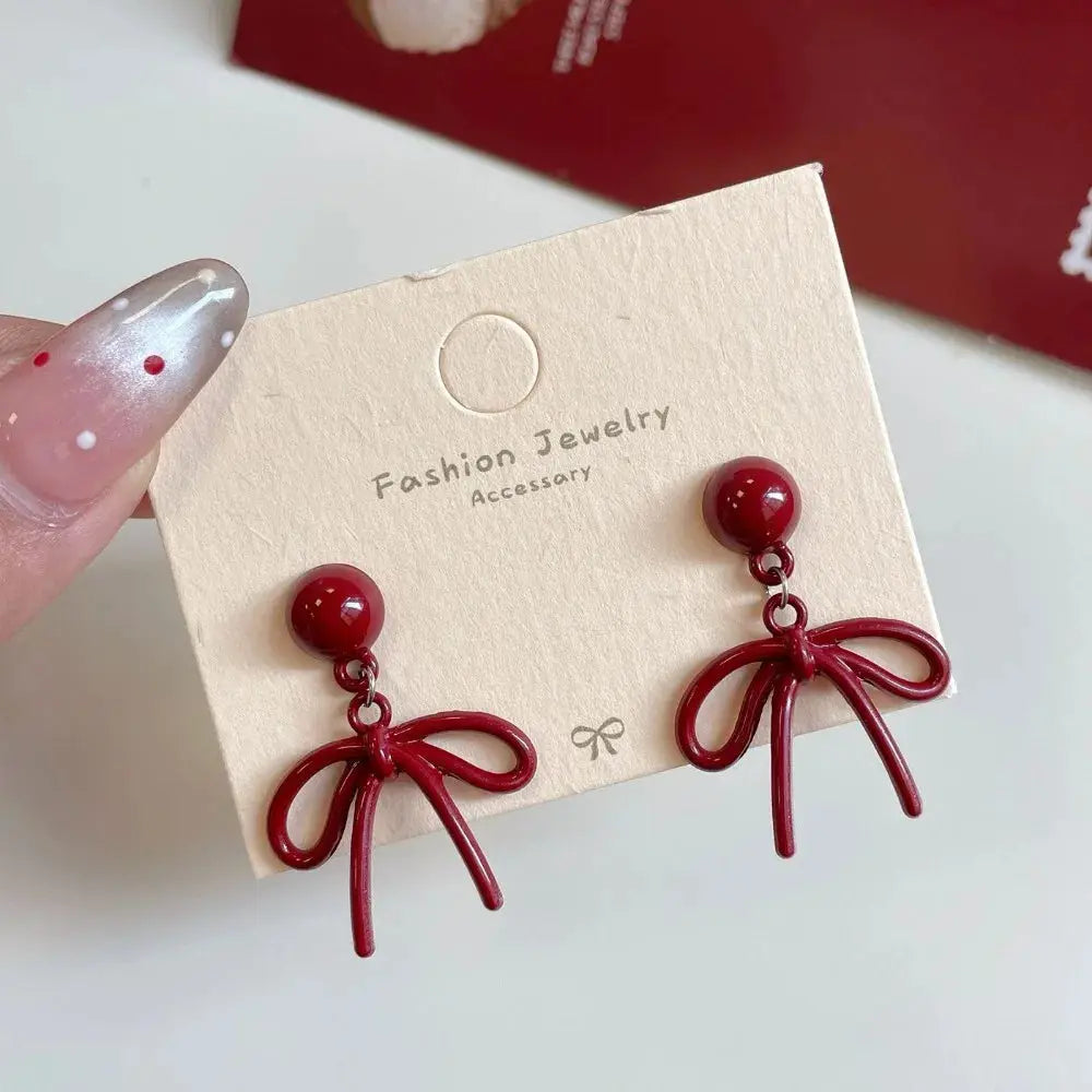 Pair of red bowknot earrings with round studs and bow-shaped dangles