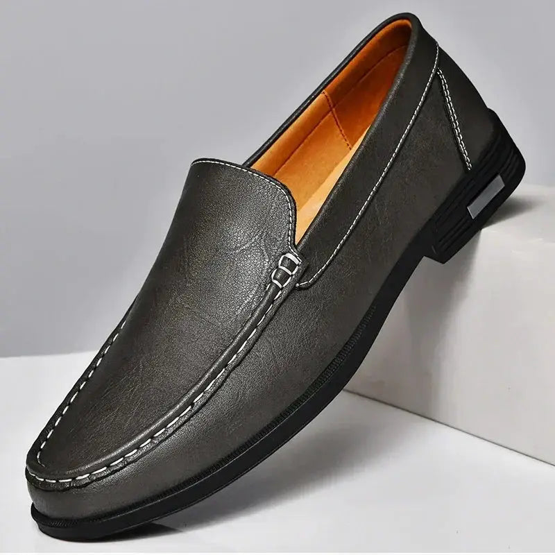 Leather men's slip-on dress loafer in gray with white contrast stitching and tan lining