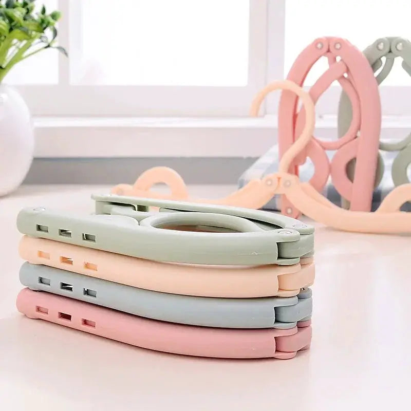 4-pack pastel foldable portable clothes hangers in green, peach, blue and pink