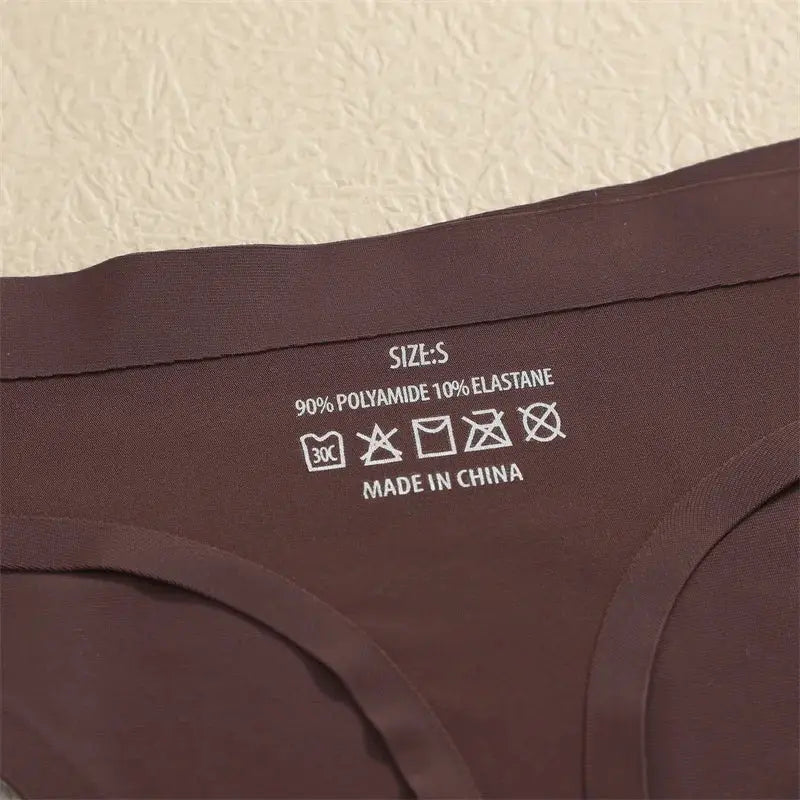 Brown Simples Market G-string thong underwear label; size S, 90% polyamide 10% elastane, care symbols, Made in China.