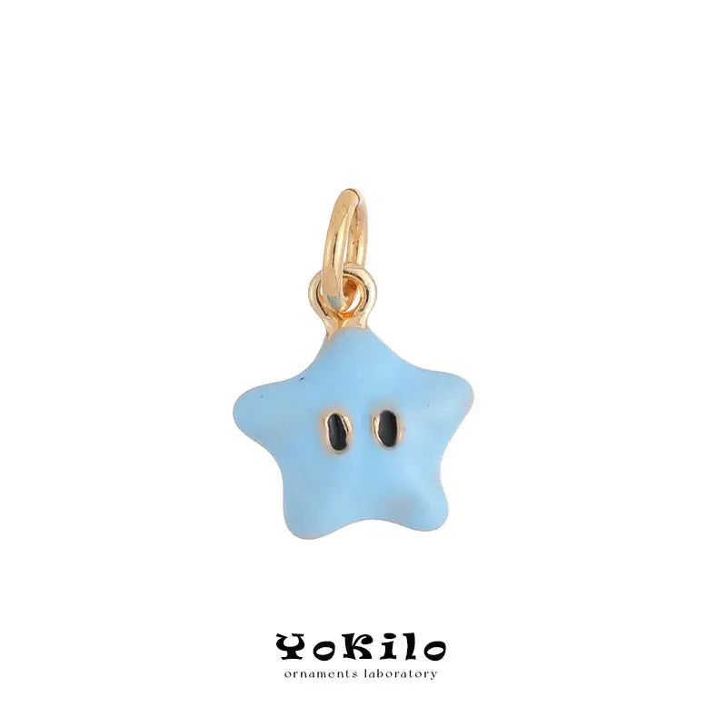 Blue star pendant earring on a gold-tone single hoop by Yokilo