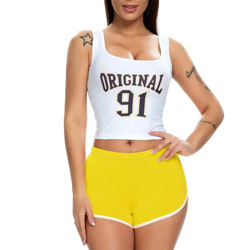Two-piece women's athletic set: white crop top with Original 91 print and yellow shorts.