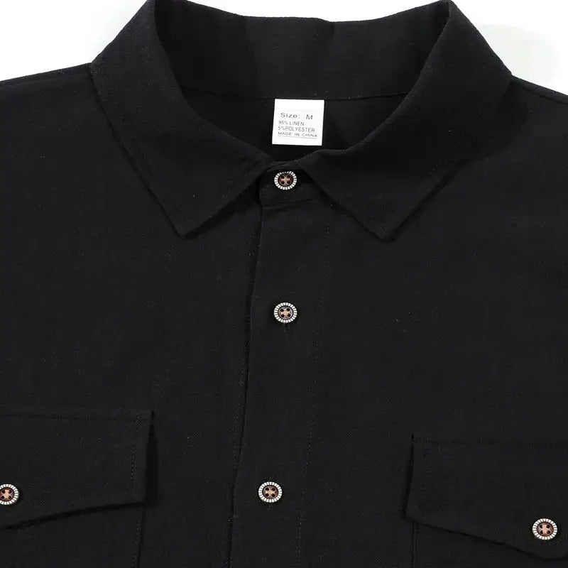 Men's black linen button-up shirt with lapel collar, short sleeves, two chest pockets.