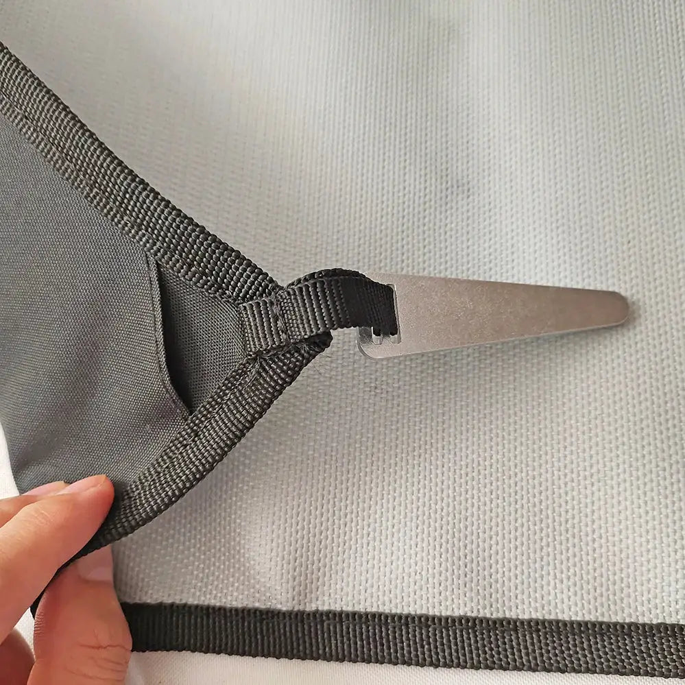 Camping fireproof grill mat in gray fabric with black strap and metal stake