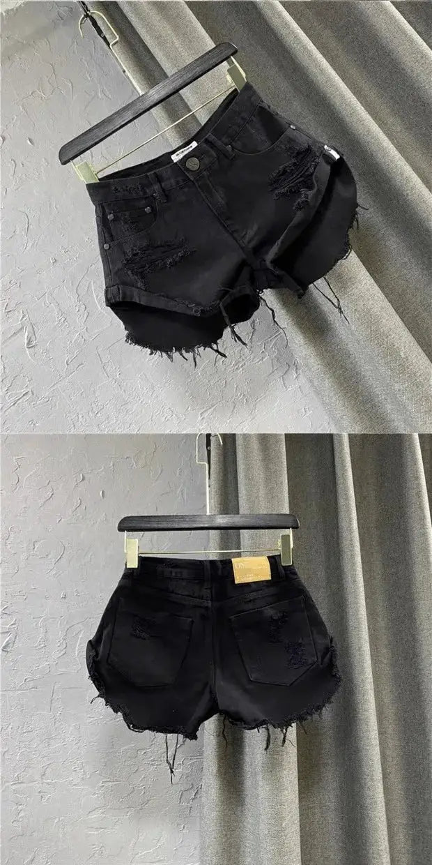 Black denim shorts by Simples Market with frayed edges, distressed patches and zip front